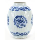 Chinese blue and white porcelain ribbed vase hand painted with flowers and scrolling foliage, Kangxi