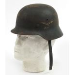 German military interest tin helmet with leather liner and decals