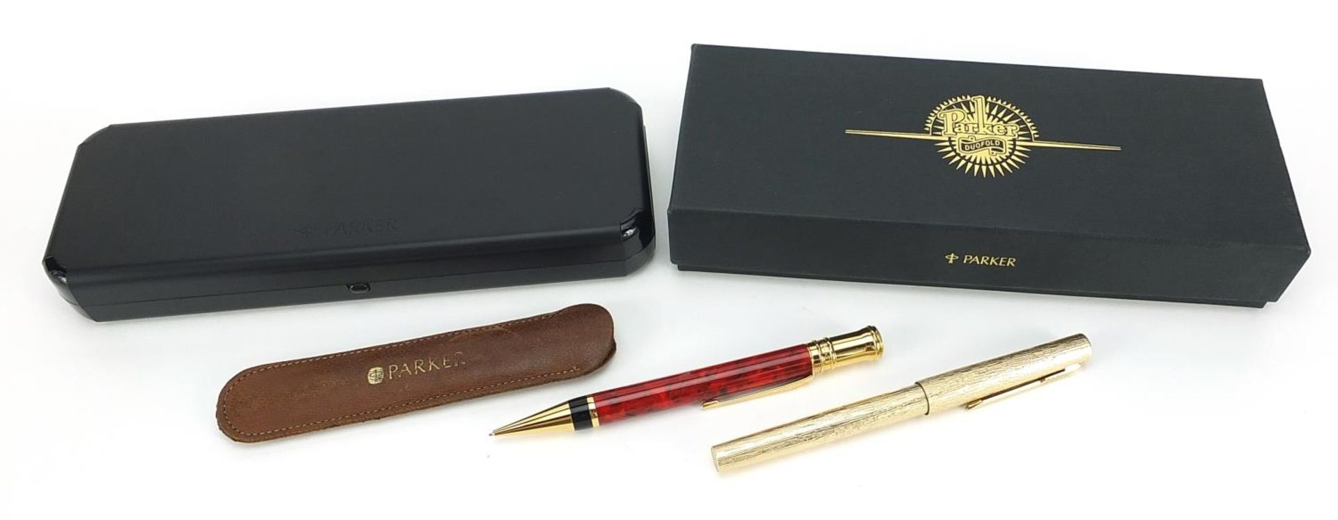 Parker Duofold red marbleised propelling pencil with case and a gold plated bark design fountain pen