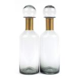 Pair of large smoky glass apothecary style jars with measure lids, 53cm high