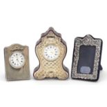 Silver items comprising two desk clocks and an easel photo frame, the largest 11cm high
