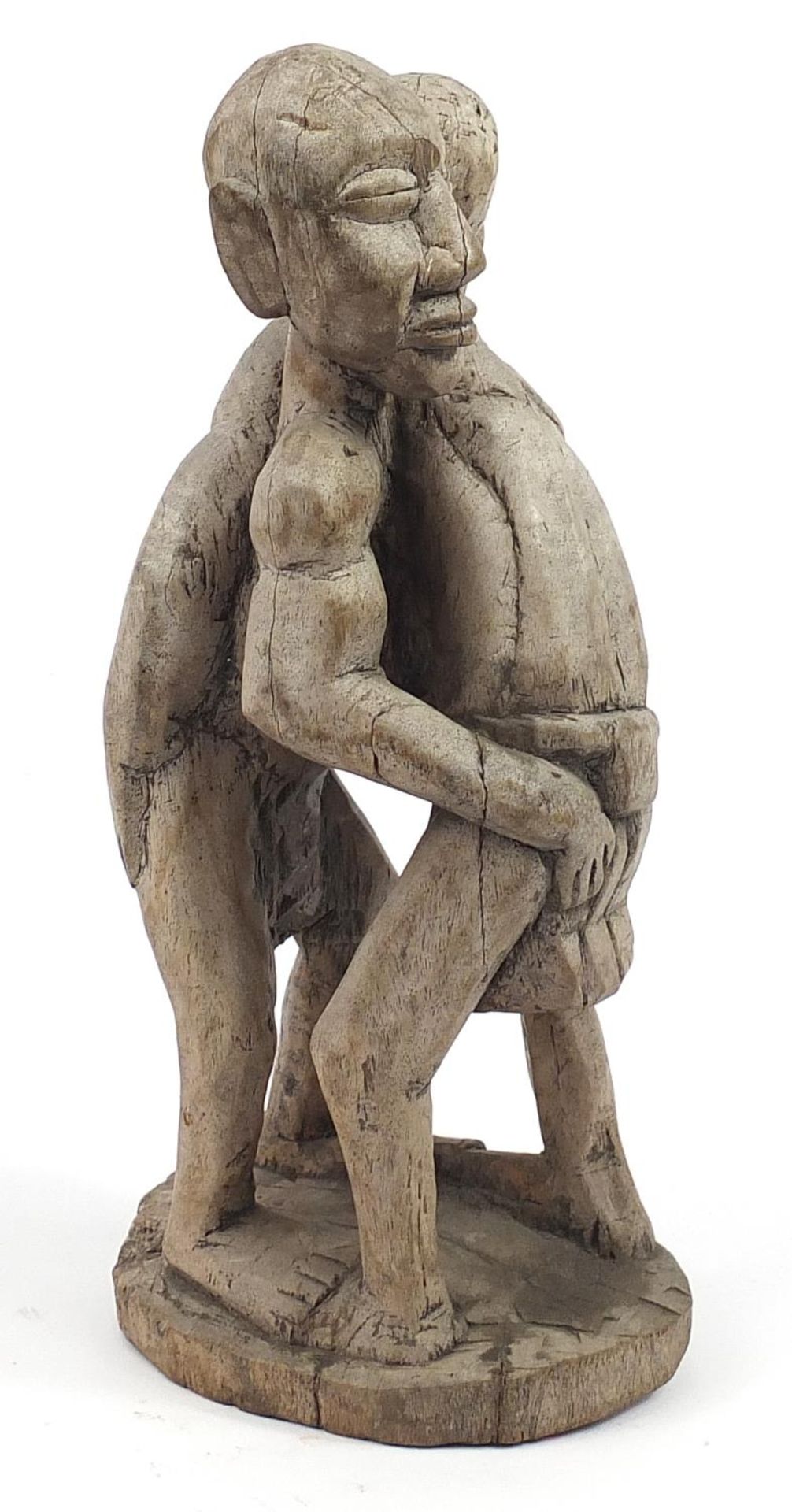 Tribal interest wood carving of two tribesmen wrestling, 40cm high