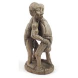 Tribal interest wood carving of two tribesmen wrestling, 40cm high