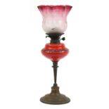 Victorian brass oil lamp with etched cranberry glass shade, 58cm high