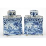 Pair of Delft tin glazed pottery tea caddies hand painted with traditional Dutch figures in