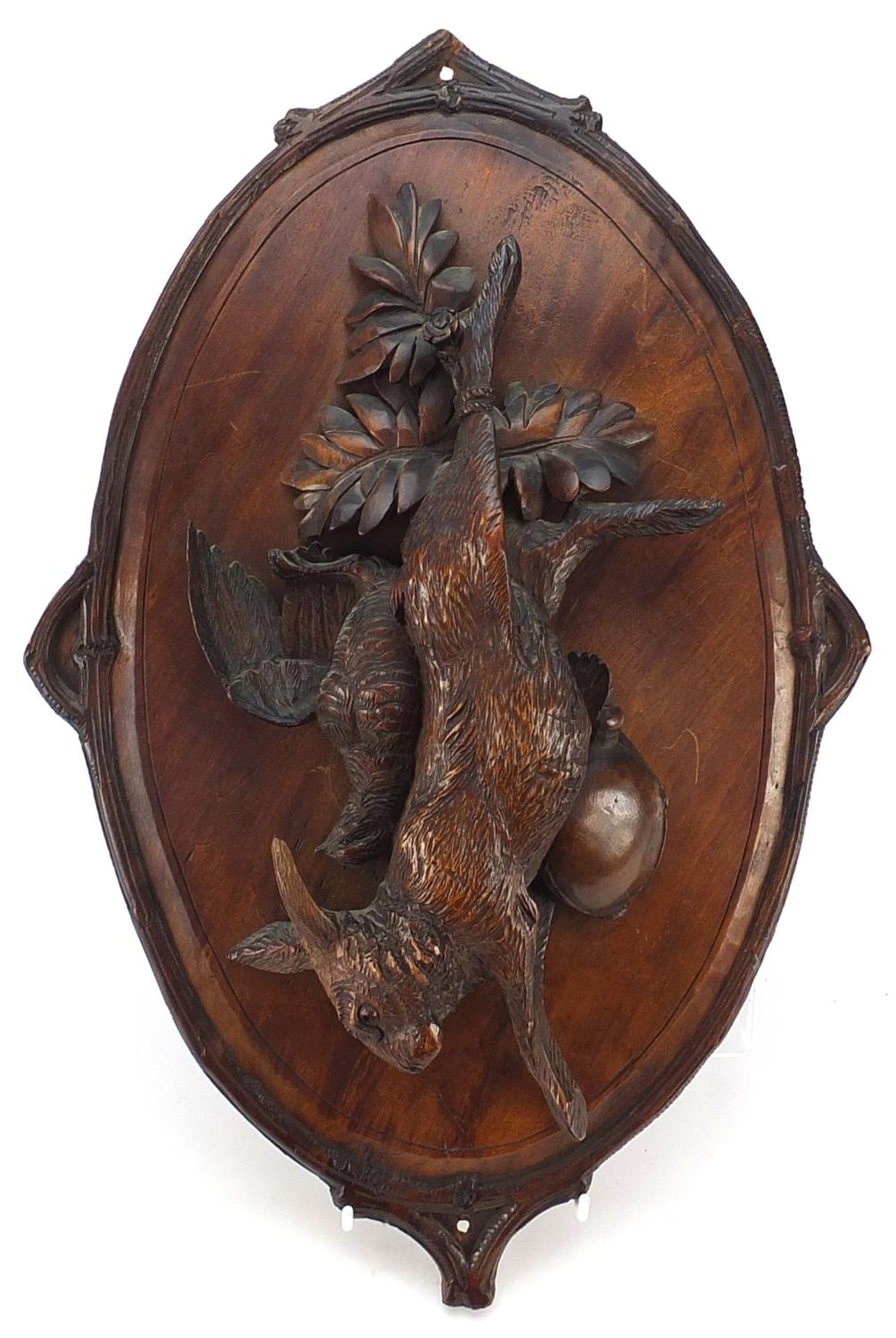 19th century German Black Forest hunting trophy plaque carved in relief with hanging game and birds,