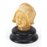 Carved ivory bust of a young girl raised on an ebonised base, 7cm high