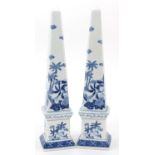 Pair of blue and white porcelain obelisks decorated with Putti amongst flowers, 41.5cm high
