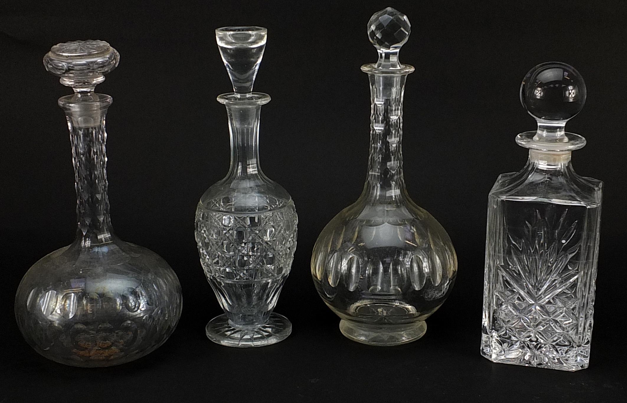 Four glass decanters with stoppers, the largest 30cm high