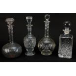 Four glass decanters with stoppers, the largest 30cm high