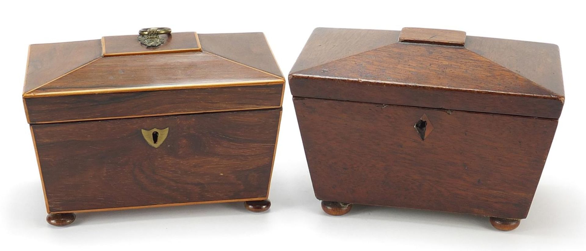 Two Victorian mahogany sarcophagus shaped tea caddies with twin divisional interiors, the largest