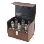 19th century leather chemists travelling case housing six glass apothecary jars, 12cm H x 15.5cm W x