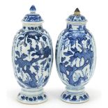 Matched pair of Chinese blue and white porcelain vases and covers hand painted with panels of
