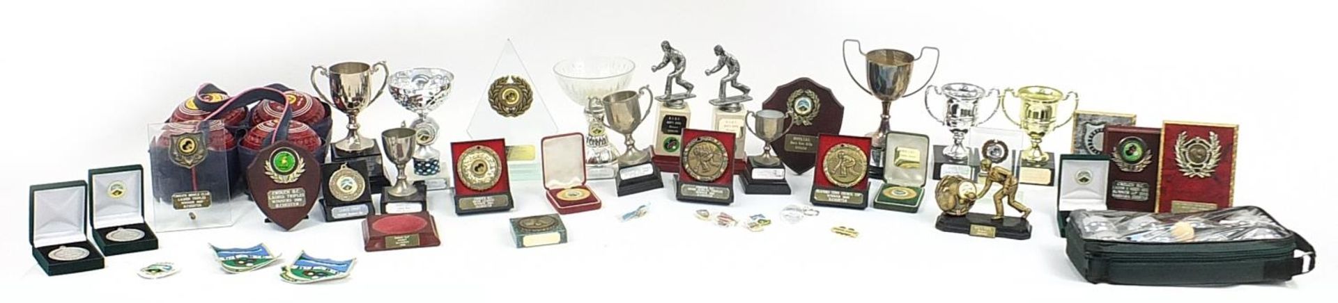 Collection of bowling trophies and a set of Thomas Taylor size 3 bowls