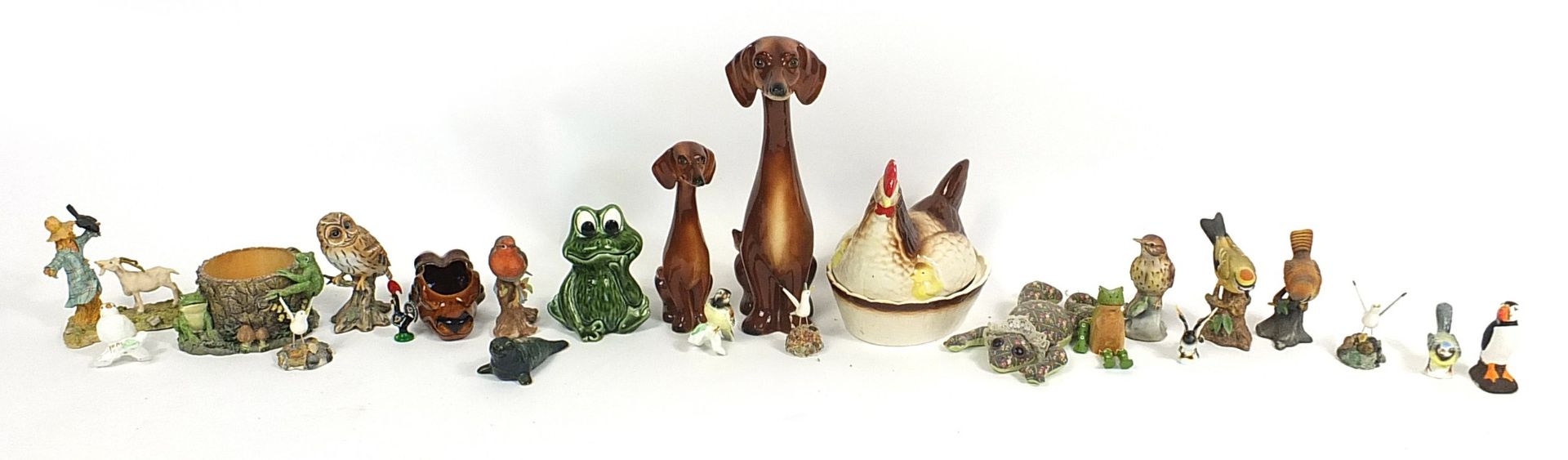 Collectable china and pottery animals including Jema style dogs, chicken egg basket and birds, the