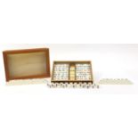 Mahjong set housed in a lightwood glazed case, 36cm wide