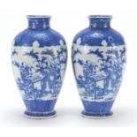 Pair of Japanese blue and white porcelain vases, each decorated with scholars in a landscape,