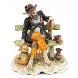 Hand painted Capodimonte figure of a tramp on a bench, 26cm high