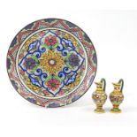 Hand painted Maiolica charger and two miniature ewers, the charger 35.5cm in diameter