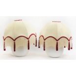 Pair of white globular pottery table lamps with silk tasselled shades, 50cm high with shades