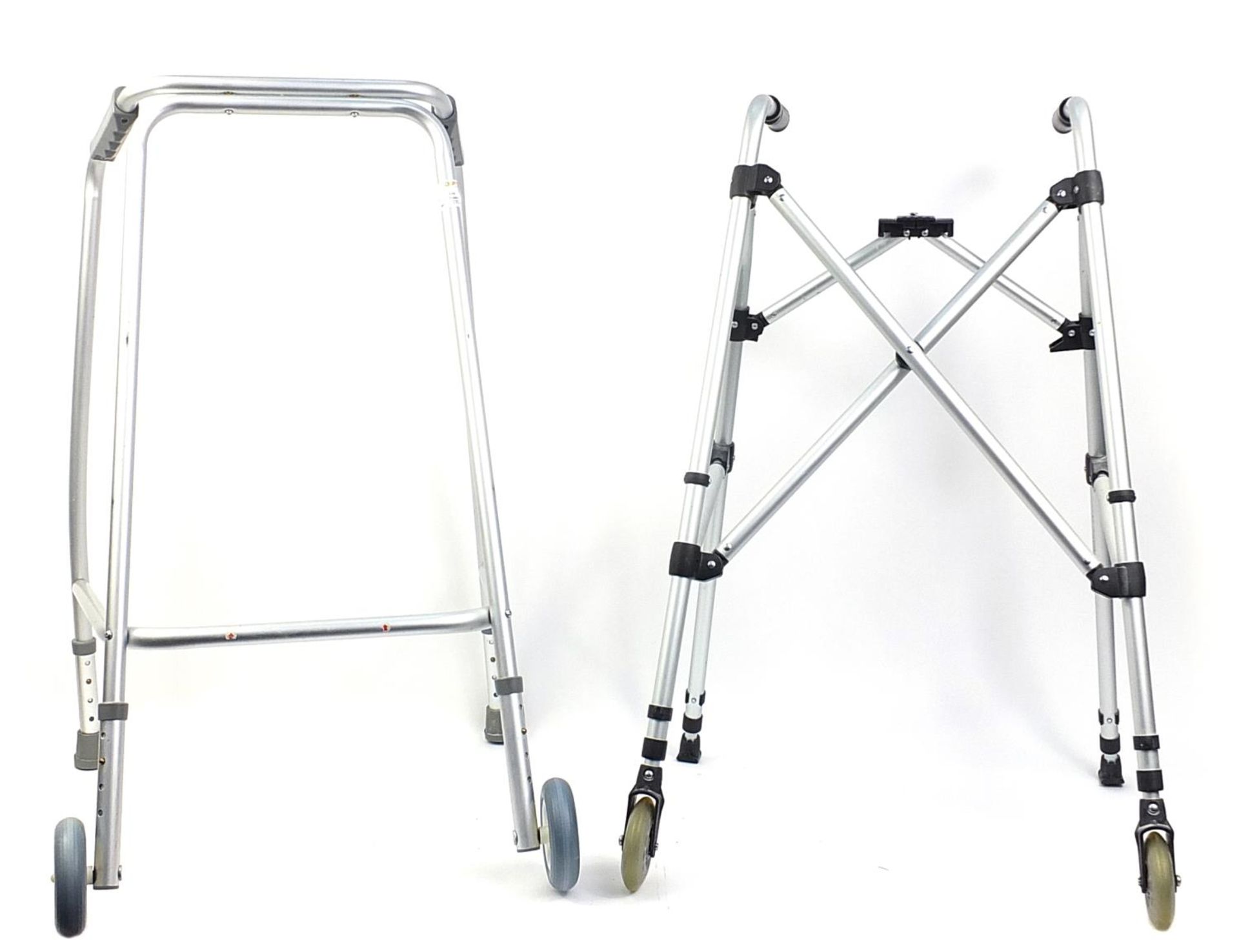 Two metal mobility aids, one foldable, each with wheels, each 89cm high