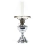 Victorian polished metal oil lamp with glass flume, 57cm high