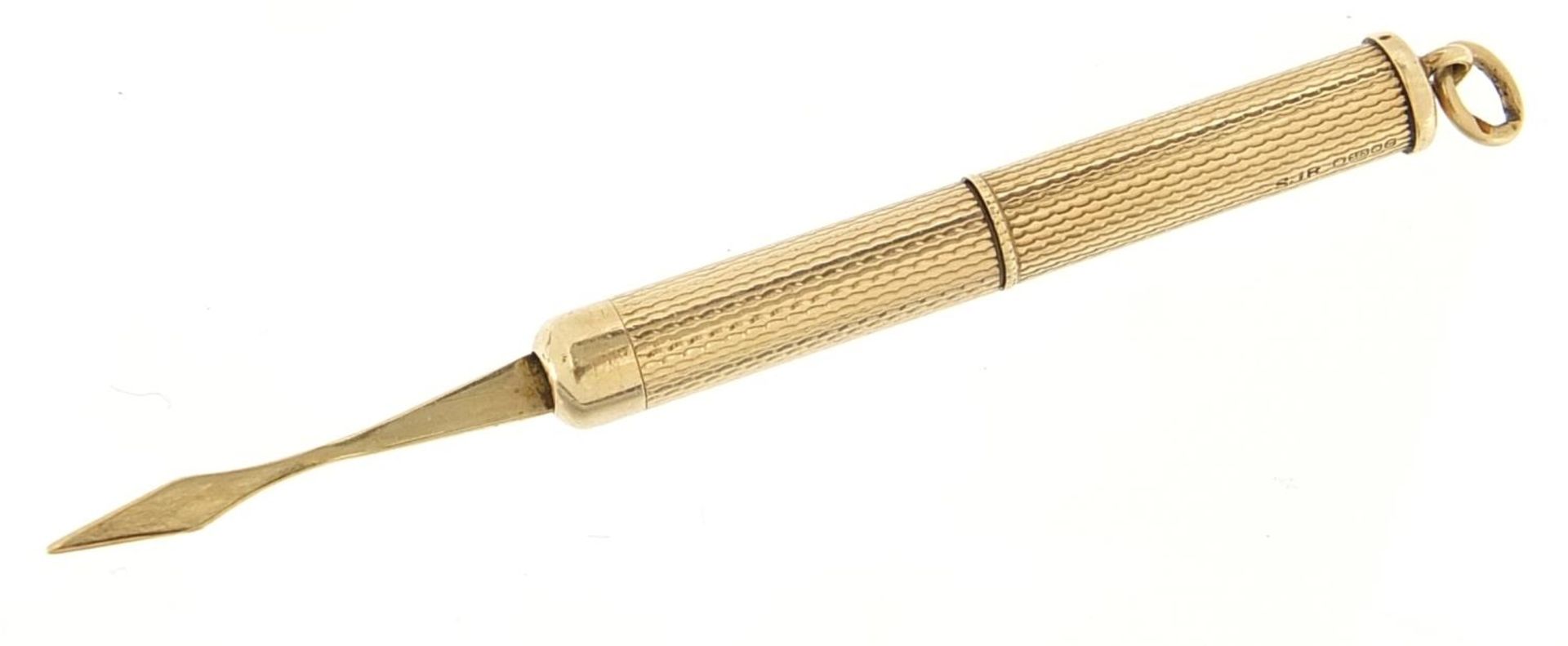 9ct gold propelling toothpick with engine turned decoration, 5.0cm in length un-extended, 6.6g