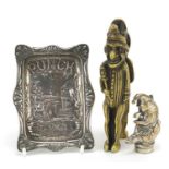 Punch related objects comprising a silver embossed pin tray, vesta and pair of nutcrackers, the