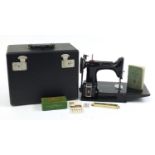 Victorian black enamel sewing machine with carry case, model 221K, the case 36cm wide