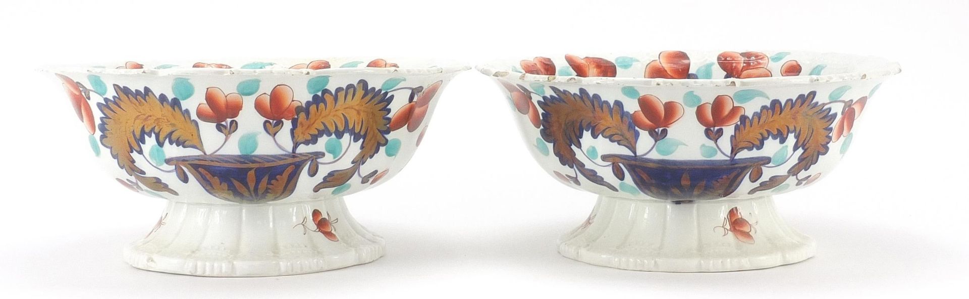 Pair of Victorian ironstone centre bowls decorated with flowers and foliage, each 29cm in diameter