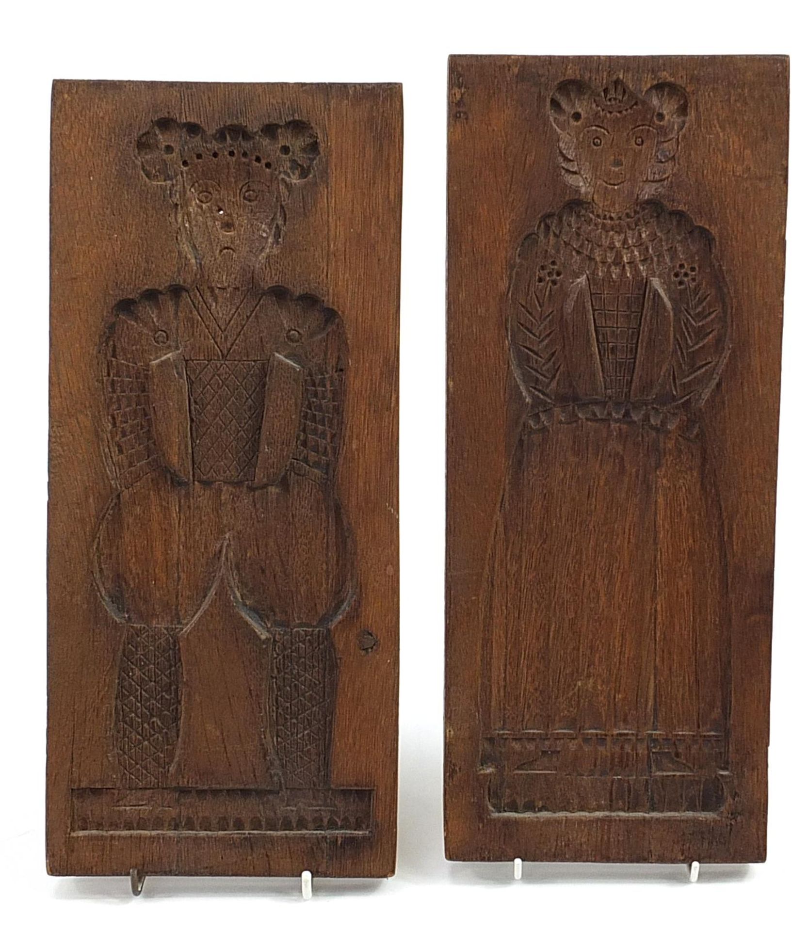 Two rectangular wooden moulds carved with figures in Elizabethan dress, each 38cm x 15.5cm