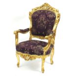 Ornate French style giltwood open armchair with purple floral upholstery, 112cm high