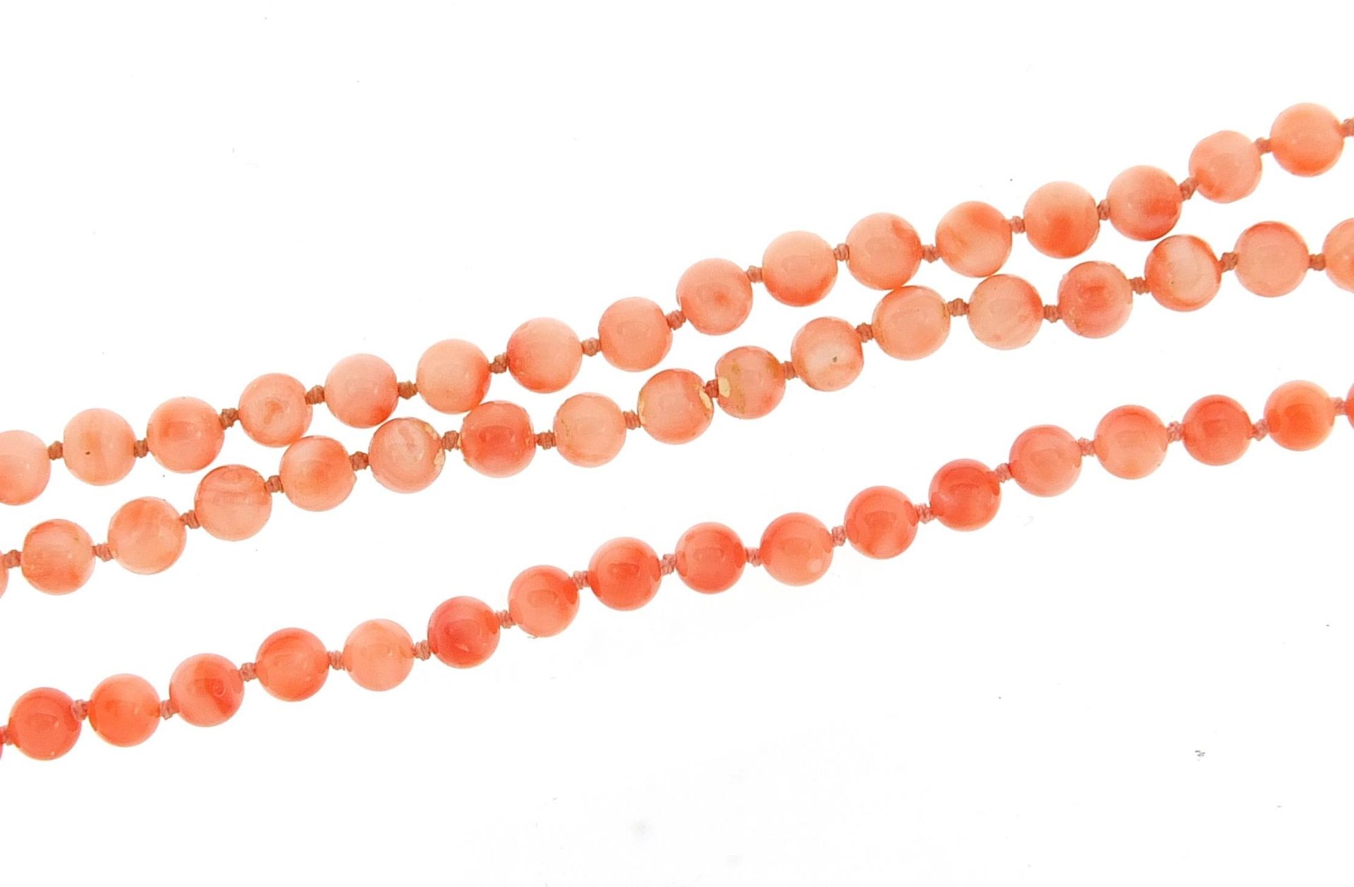 Pink coral bead necklace and bracelet, each with 9ct gold clasp, 44cm and 18cm in length, 23.5g