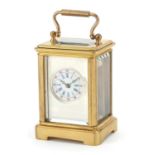 Miniature brass cased carriage clock with enamelled dial and swing handle, 5.5cm high