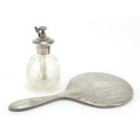 George V silver backed hand mirror and cut glass atomiser with silver top, the largest 27cm in