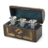 19th century dome topped leather casket with brass mounts housing three glass scent bottles, 10cm