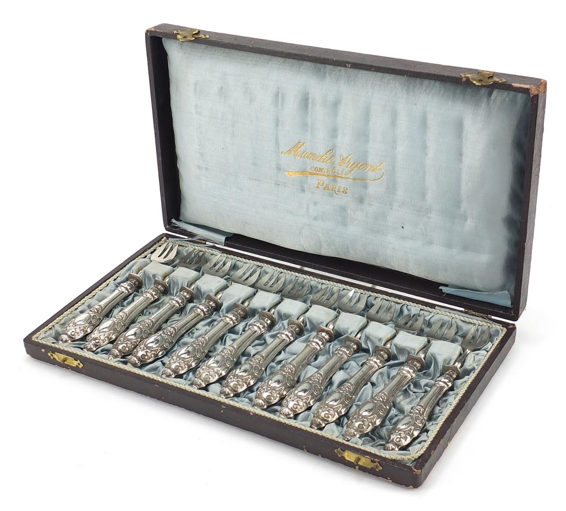 Set of twelve French silver handled forks embossed with Putti housed in a fitted Manche Argent