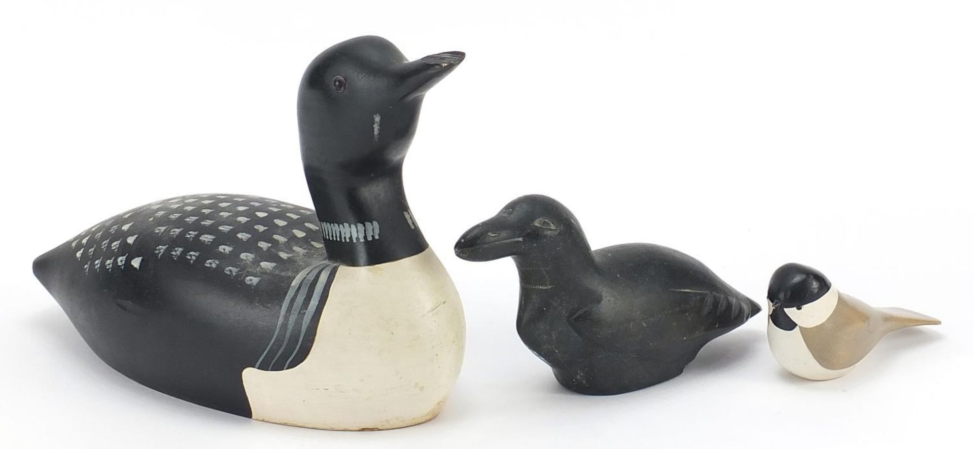 Two Canadian carved wood duck decoys and an Inuit carved stone duck, the largest 33.5cm in length
