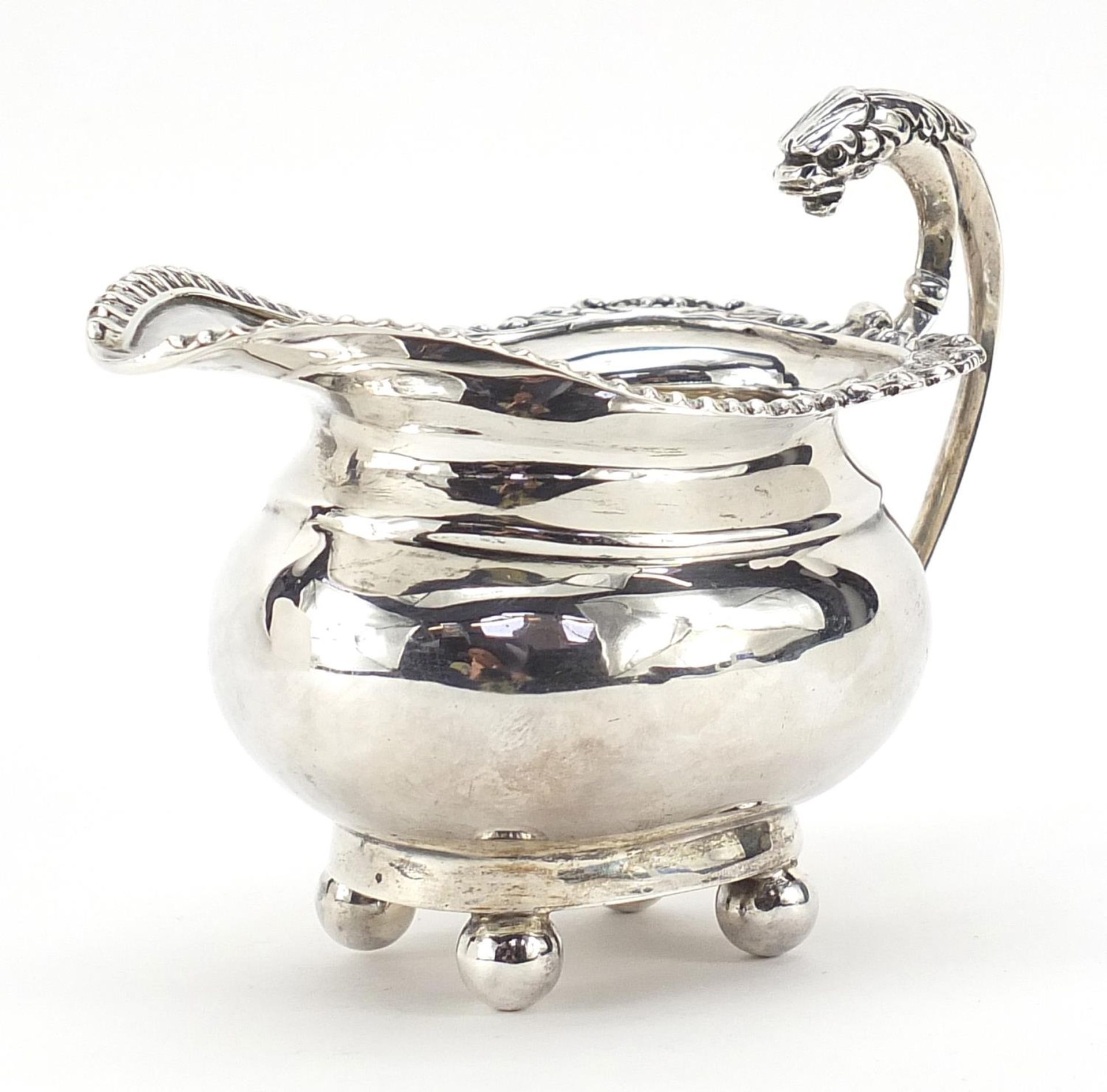 Mappin & Webb, George V silver cream jug with griffin handle and ball feet, Birmingham 1911, 11cm in
