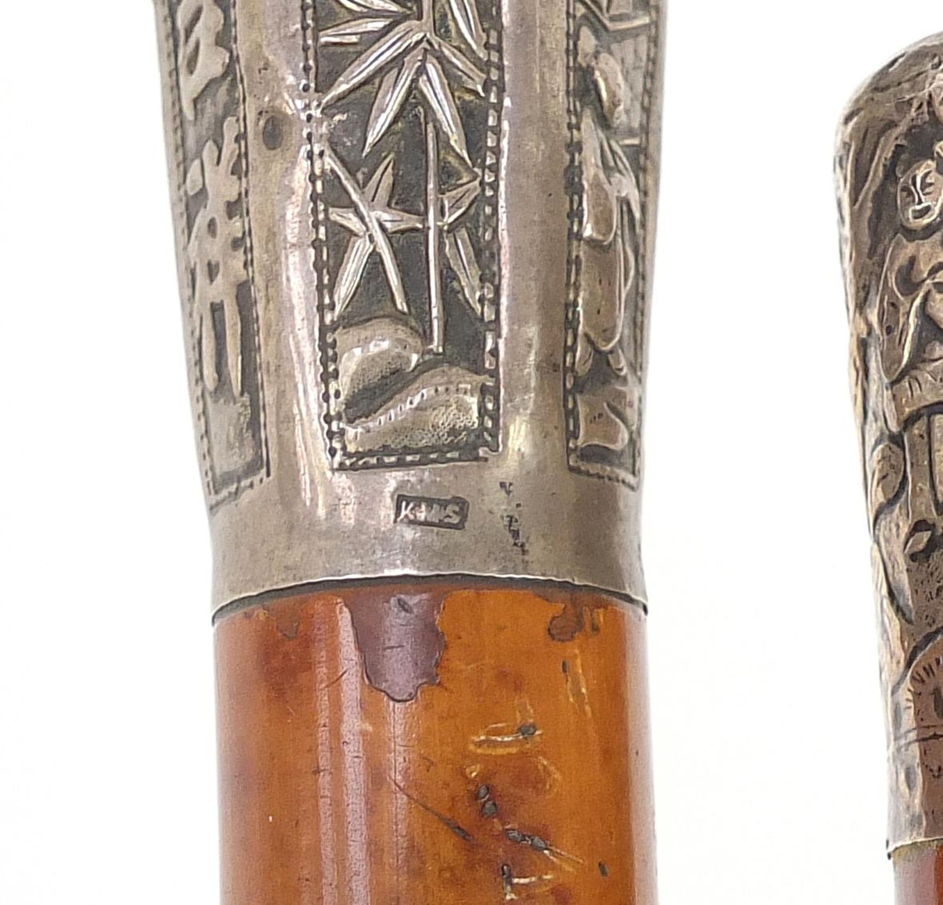 Two malacca walking sticks with Chinese silver pommels embossed with figures and calligraphy, the - Image 4 of 4