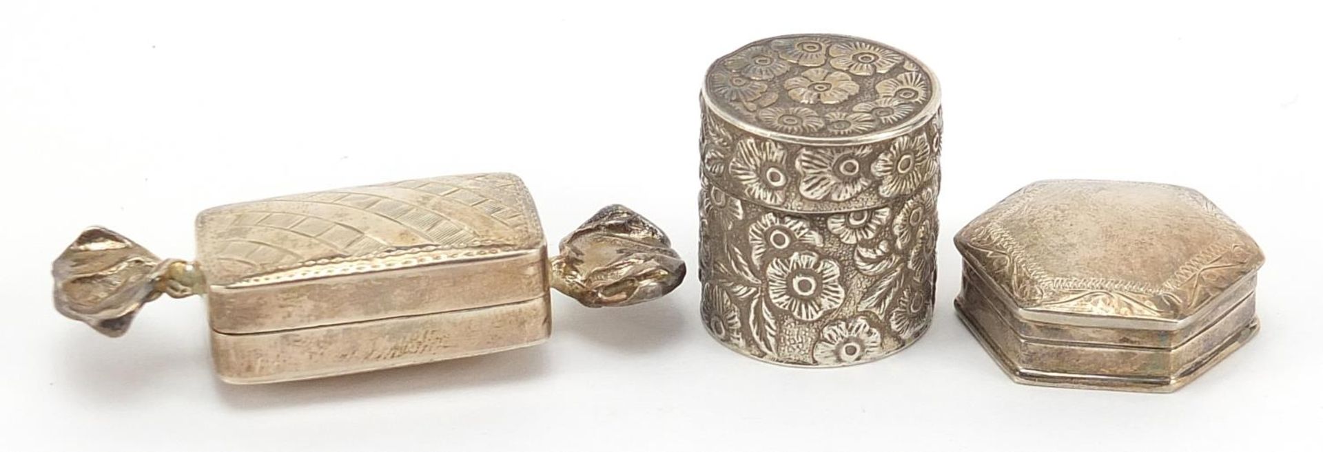 Three silver trinket and patch boxes, one with embossed decoration, the largest 6.2cm wide, total