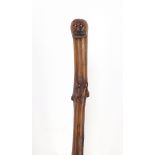 Root wood walking stick with carved figural pommel, 88cm in length