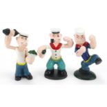 Three painted cast iron figures of Popeye, the largest 16cm high