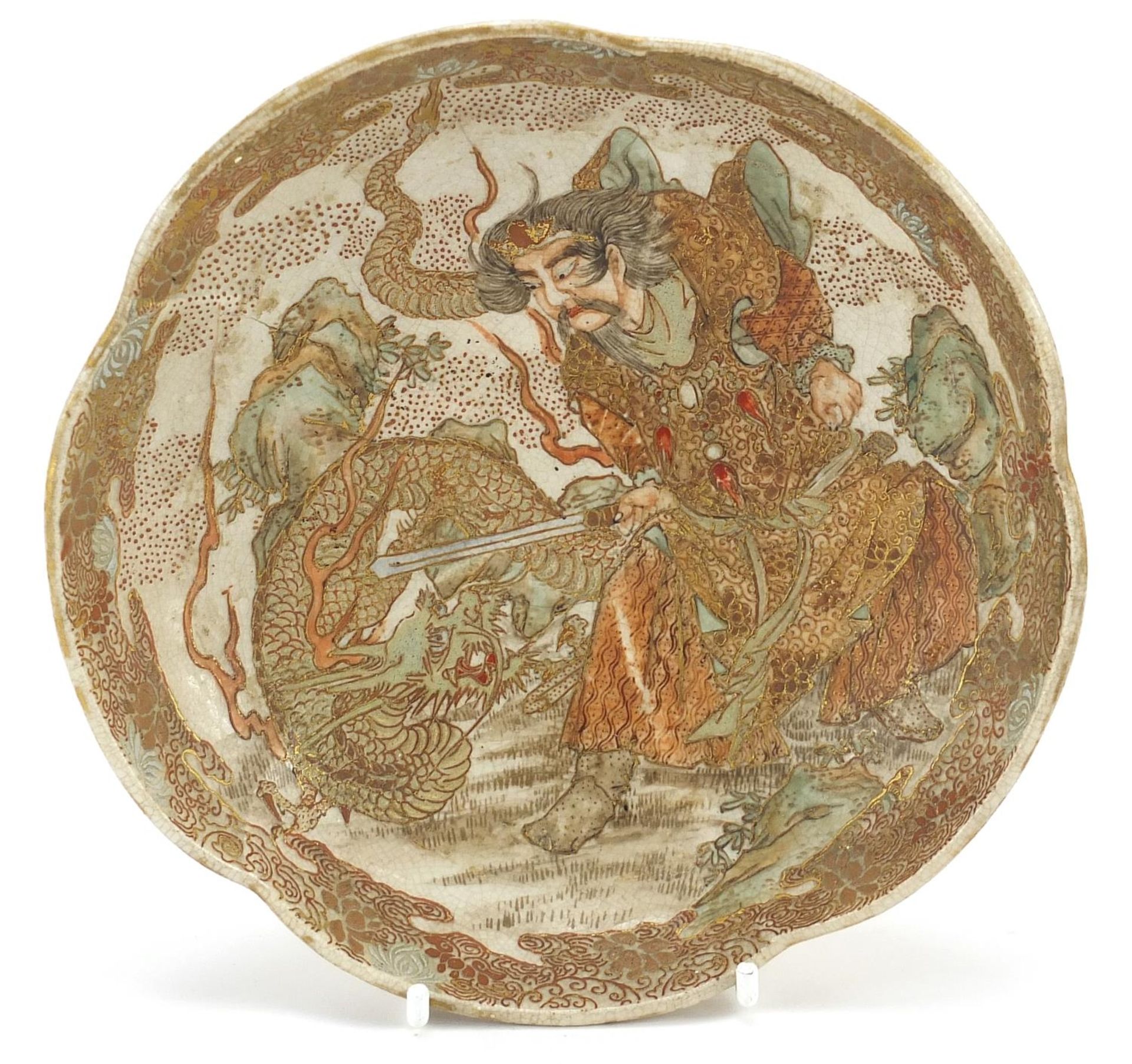 Japanese Satsuma pottery dish hand painted with a demon fighting a dragon, 17cm in diameter