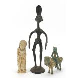 Tribal metalware and a stone carving including partially gilt model of a figure on horseback, the