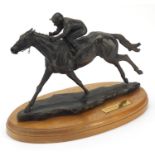 Bronzed model of racehorse Dancing Brave, raised on a circular oak base, 38cm wide