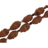 Chinese coquilla nut bead necklace carved with faces, each bead approximately 3cm in length