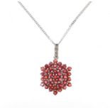9ct white gold garnet and diamond cluster pendant on a 9ct white gold necklace, 2.9cm high and