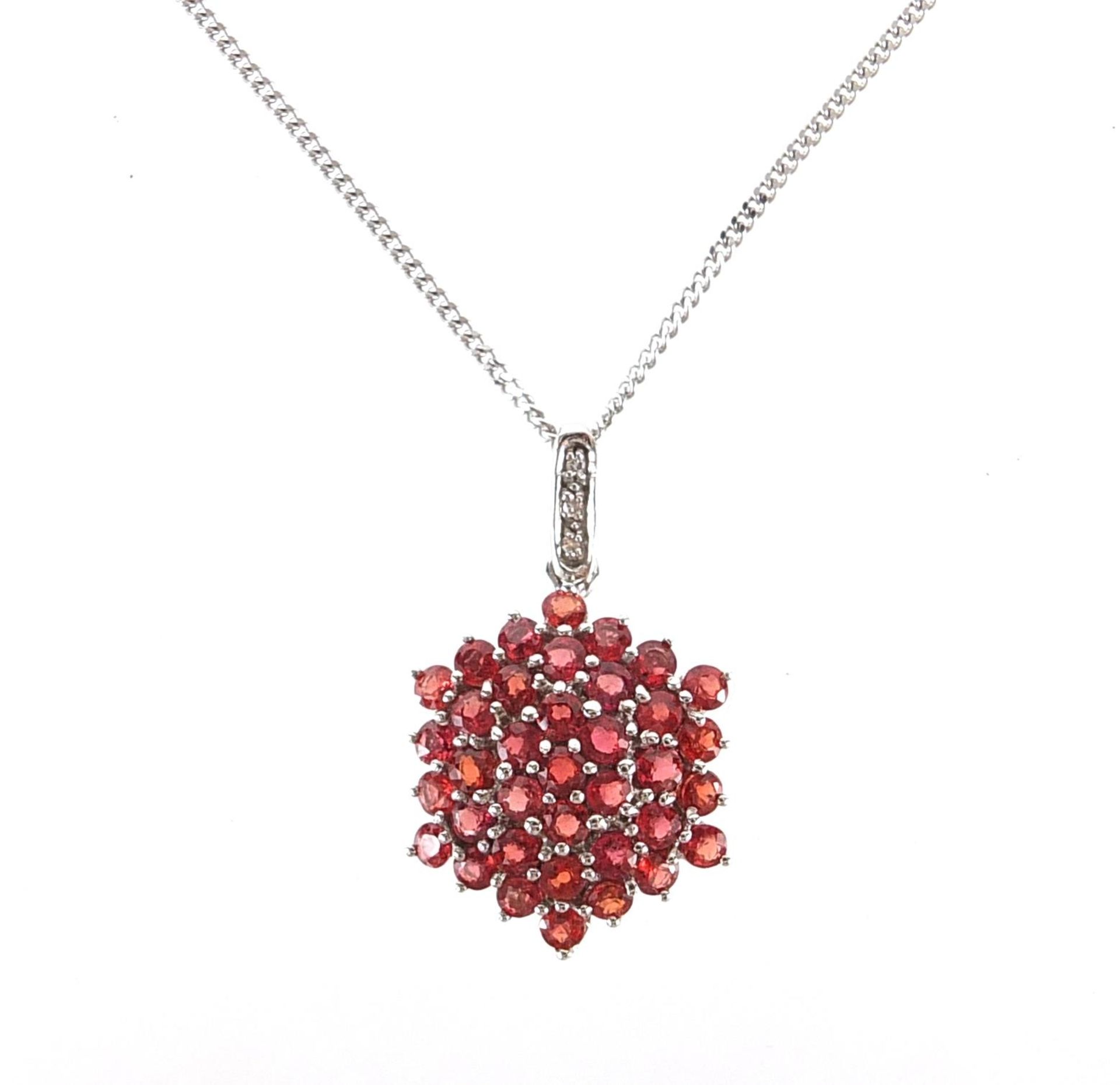 9ct white gold garnet and diamond cluster pendant on a 9ct white gold necklace, 2.9cm high and