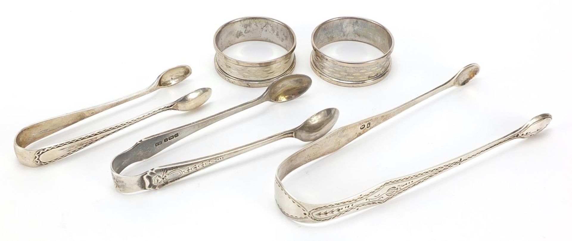 Three pairs of Georgian and later silver sugar tongs and pair of circular silver napkin rings, the - Image 2 of 4